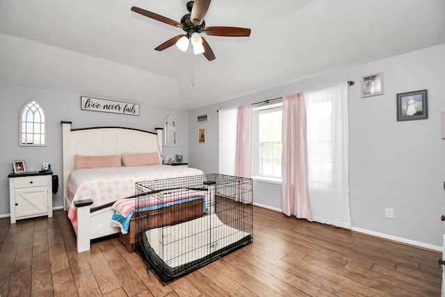 bedroom featuring multiple windows, ceiling fan, and dark hardwood / wood-style floors