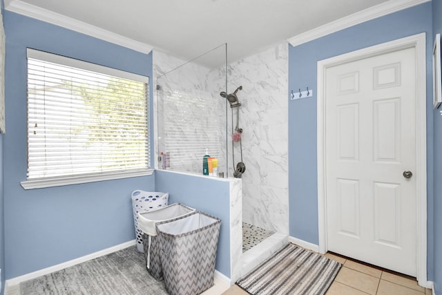 bathroom featuring tiled shower, crown molding, and tile patterned floors