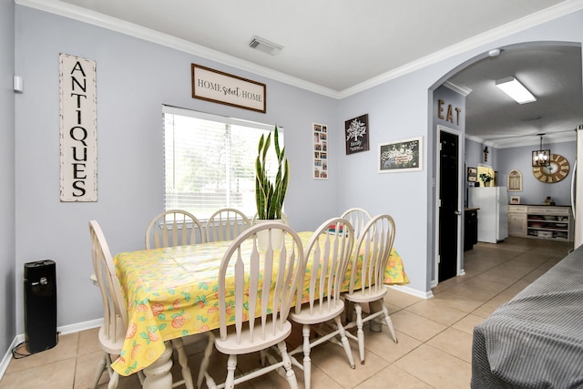 tiled dining area with crown molding