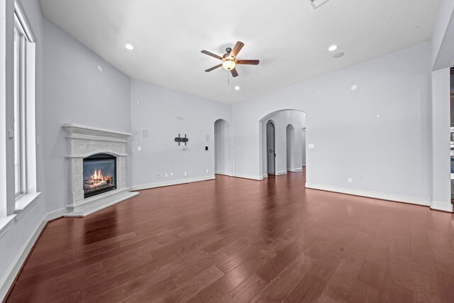 unfurnished living room featuring ceiling fan and dark hardwood / wood-style floors