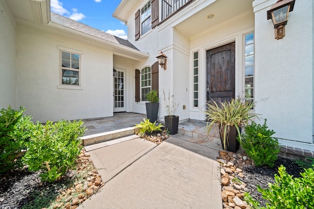 view of exterior entry with a patio area