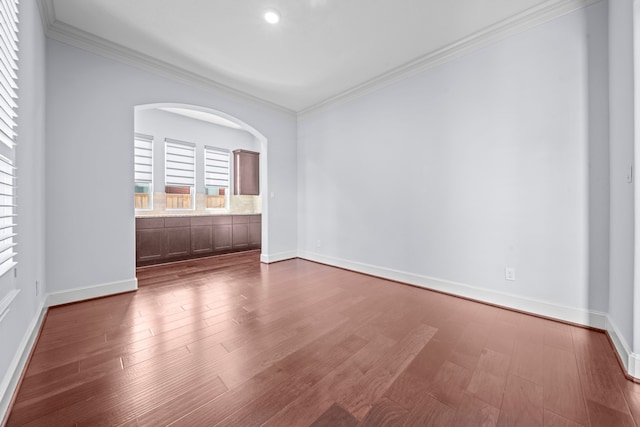 unfurnished room featuring crown molding and hardwood / wood-style floors