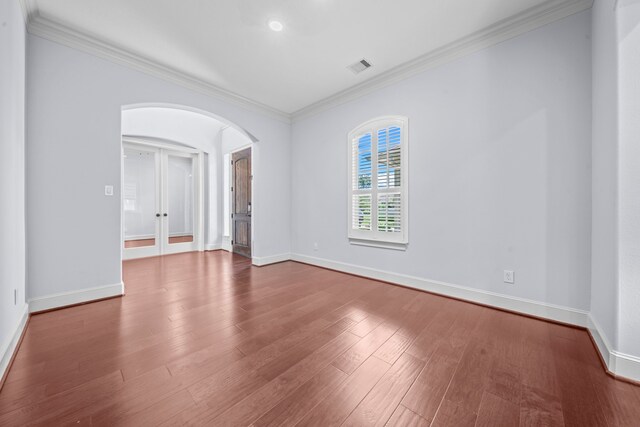 unfurnished room featuring french doors, hardwood / wood-style flooring, and crown molding