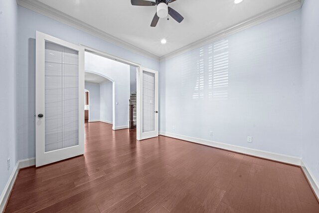 unfurnished room with ceiling fan, ornamental molding, french doors, and dark hardwood / wood-style flooring