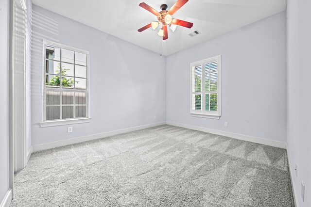 carpeted spare room with ceiling fan