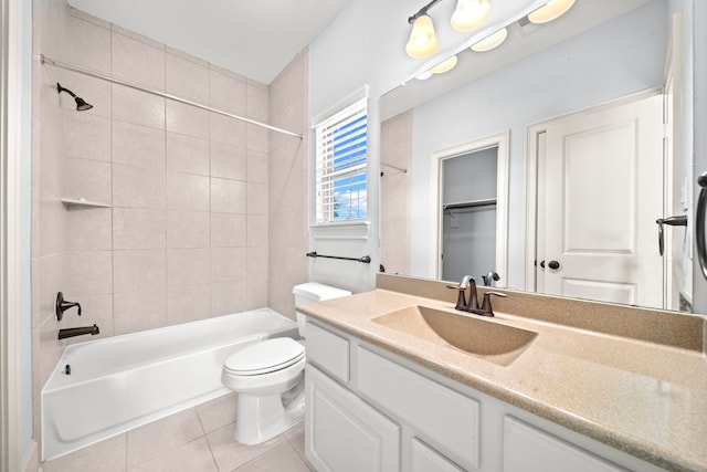 full bathroom with vanity, tiled shower / bath combo, toilet, and tile patterned flooring