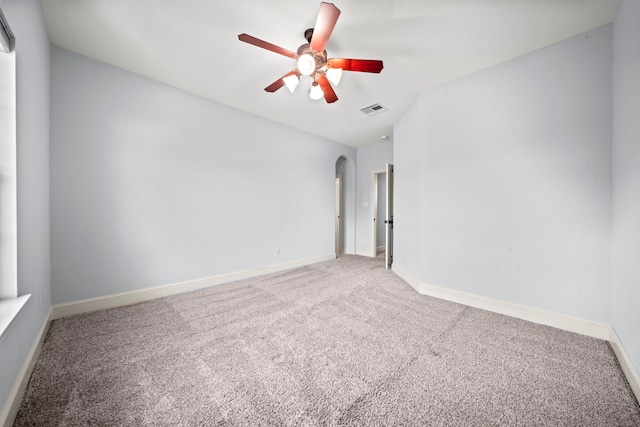 spare room with ceiling fan and carpet