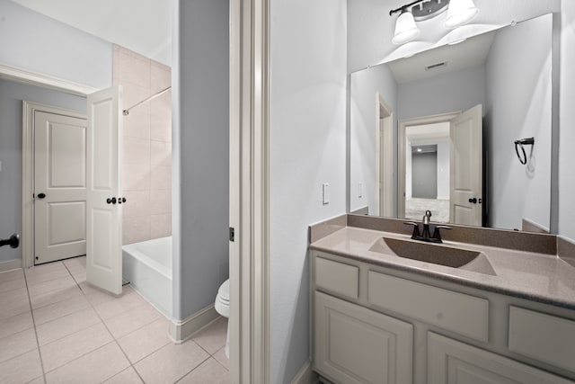 full bathroom featuring tiled shower / bath combo, tile patterned floors, vanity, and toilet