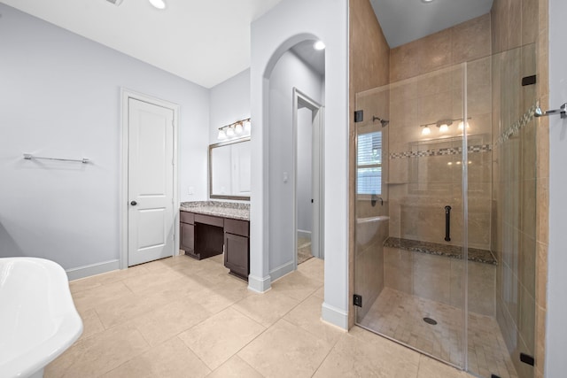 bathroom with tile patterned floors, vanity, and plus walk in shower