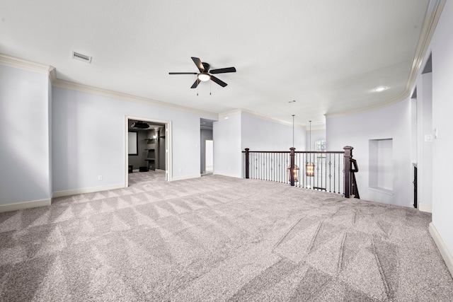 empty room with ceiling fan with notable chandelier, crown molding, and light colored carpet