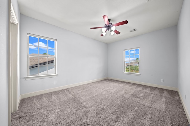 carpeted spare room with ceiling fan