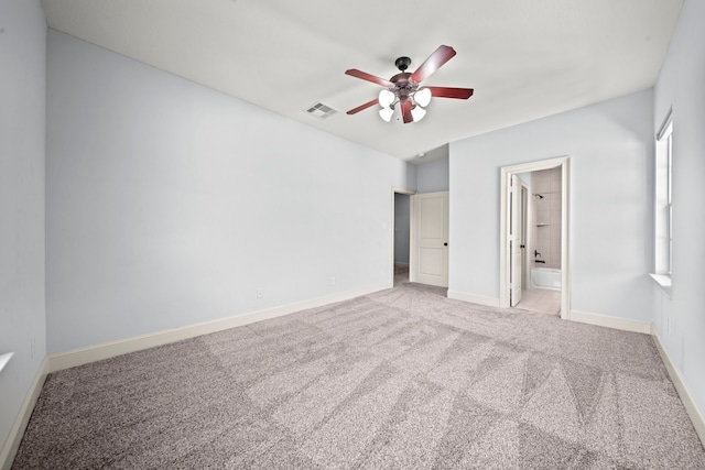 unfurnished bedroom featuring light carpet, ensuite bath, and ceiling fan