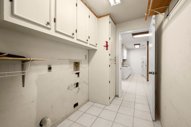 washroom with hookup for a washing machine, light tile patterned flooring, cabinets, and hookup for an electric dryer