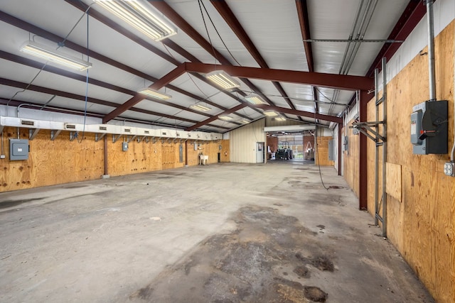 garage featuring wood walls and electric panel