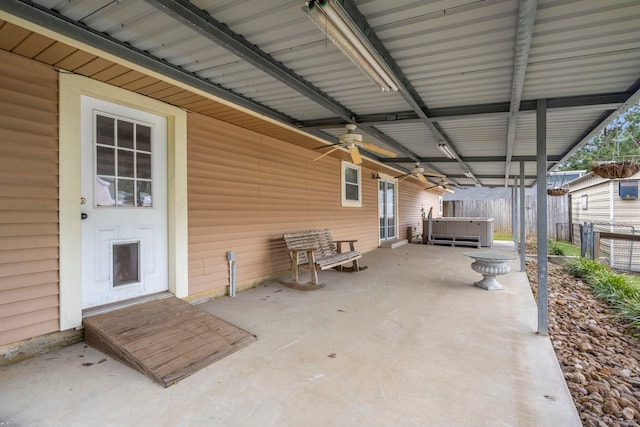 view of patio / terrace featuring ceiling fan and a hot tub