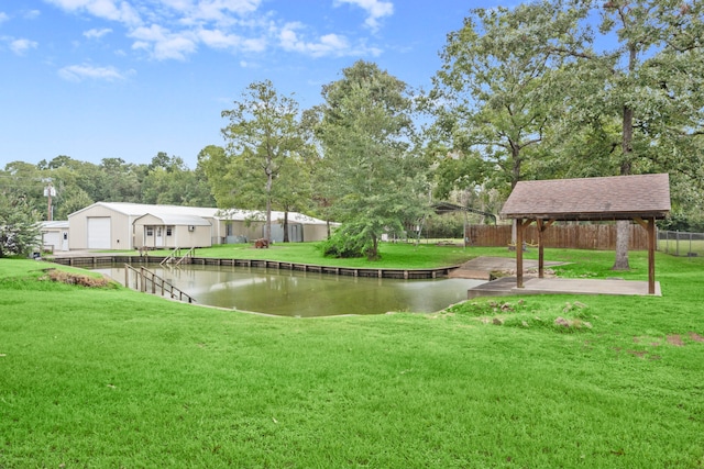 view of home's community with a water view, a yard, and a patio area