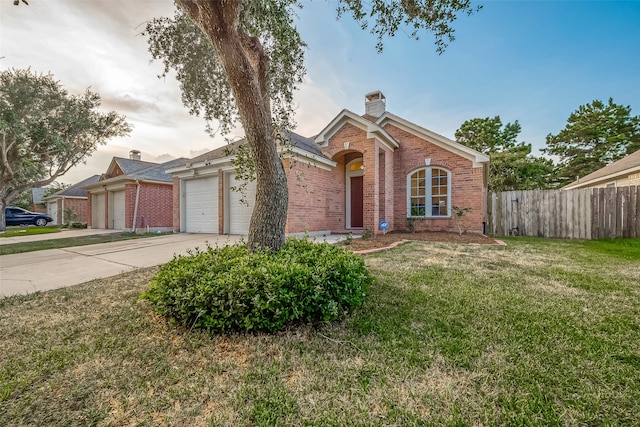 view of front of home featuring a garage and a front yard