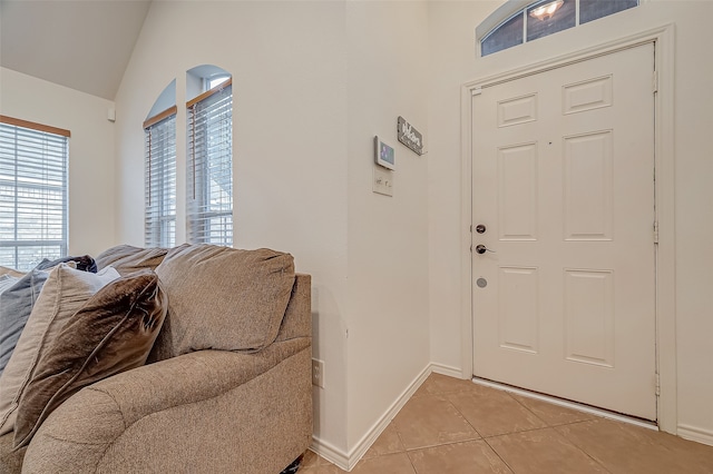 foyer entrance featuring lofted ceiling and light tile patterned floors