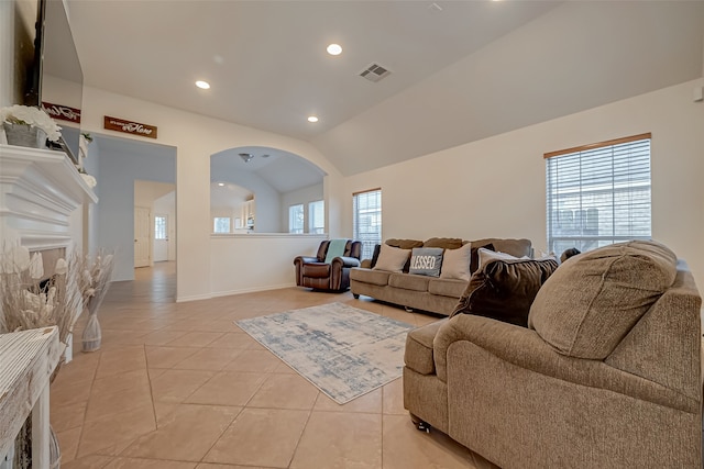 living room featuring light tile patterned floors and vaulted ceiling