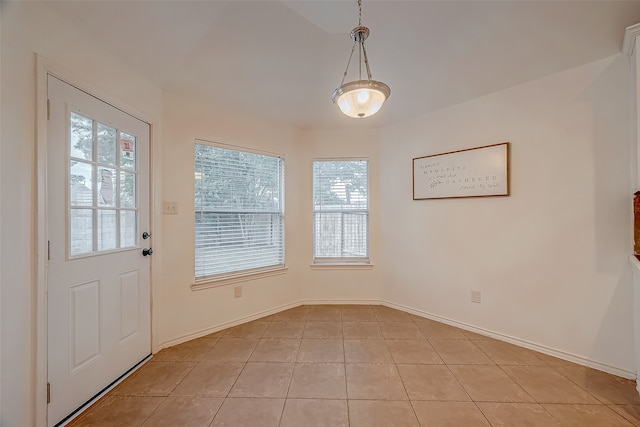 doorway to outside with light tile patterned flooring and a healthy amount of sunlight