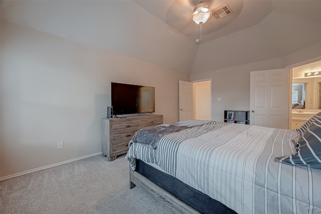 carpeted bedroom featuring vaulted ceiling, connected bathroom, and ceiling fan