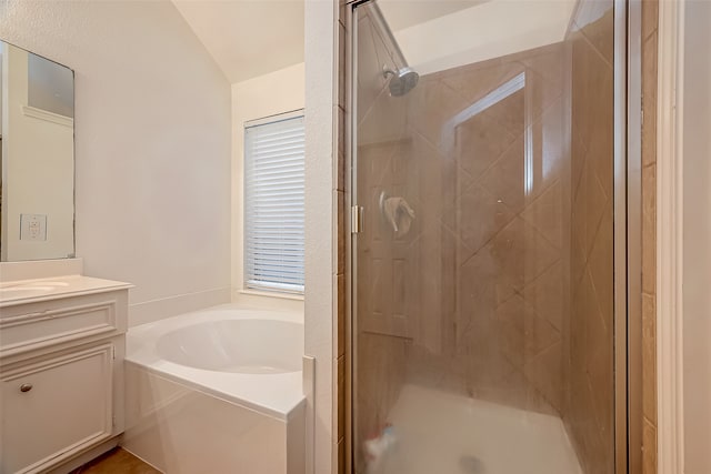 bathroom featuring vanity, separate shower and tub, and vaulted ceiling