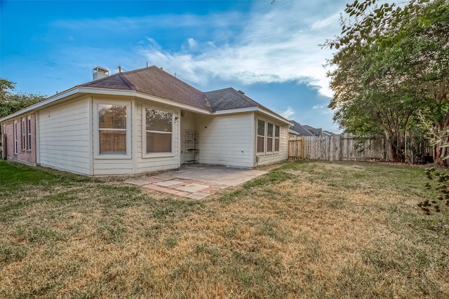 back of house with a yard and a patio area