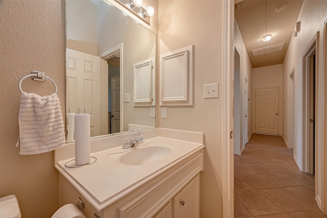 bathroom with tile patterned flooring, toilet, and vanity