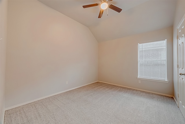 unfurnished room with lofted ceiling, light colored carpet, and ceiling fan