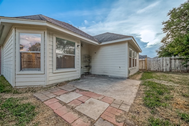 back of house with a yard and a patio