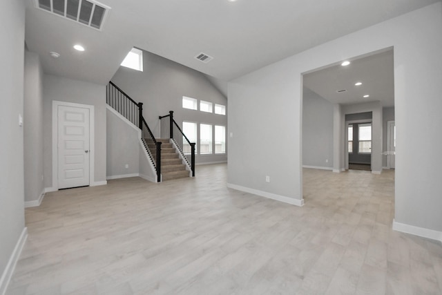 spare room with a healthy amount of sunlight and light hardwood / wood-style floors