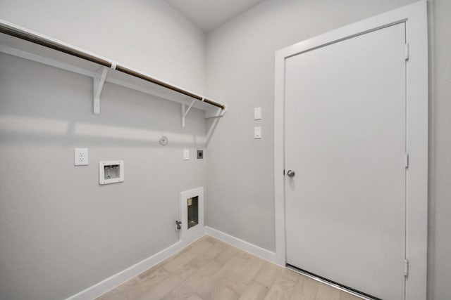 clothes washing area featuring hookup for an electric dryer, hookup for a washing machine, light hardwood / wood-style floors, and gas dryer hookup