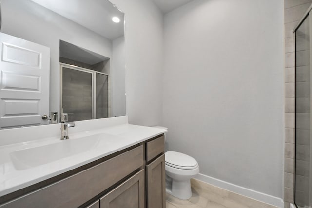 bathroom with vanity, toilet, and walk in shower