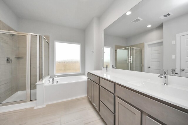 bathroom with tile patterned floors, vanity, and independent shower and bath