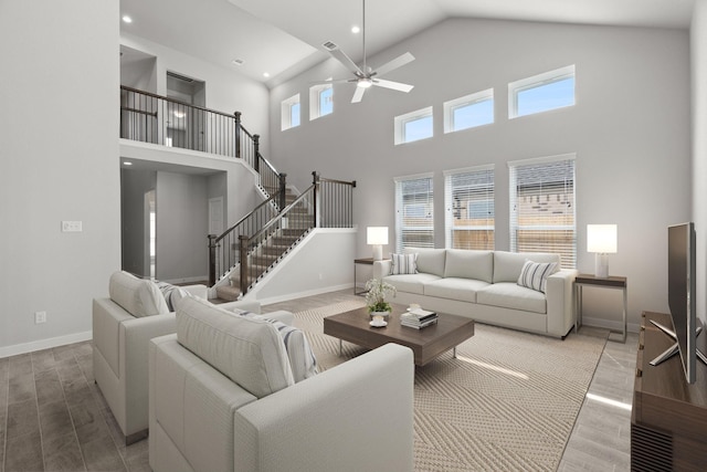 living room featuring a towering ceiling and ceiling fan