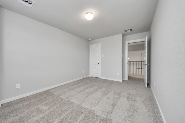 unfurnished bedroom featuring light carpet