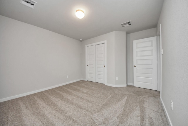 unfurnished bedroom with carpet flooring and a closet