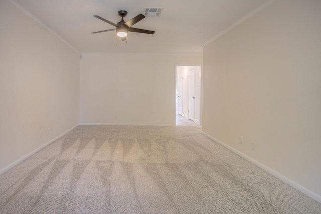 spare room with ceiling fan, crown molding, carpet flooring, and visible vents