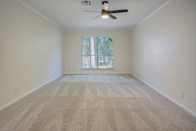 spare room featuring light colored carpet, ceiling fan, and ornamental molding