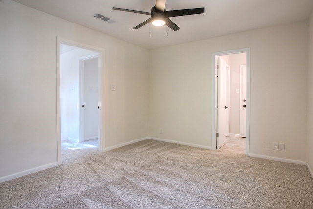 unfurnished room featuring visible vents, carpet flooring, baseboards, and ceiling fan