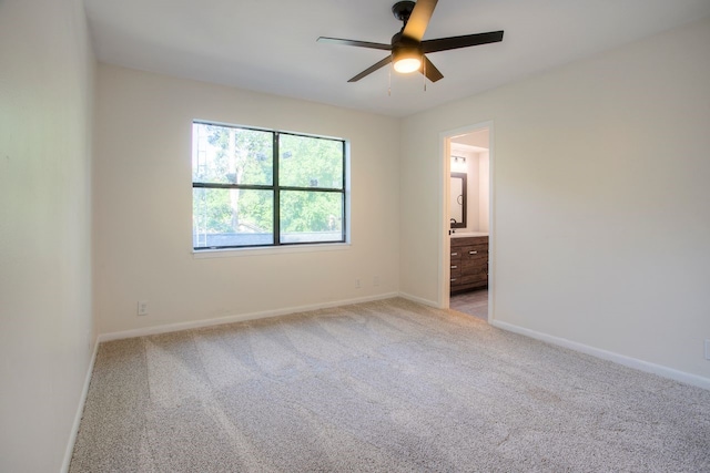 unfurnished room featuring ceiling fan, baseboards, and light colored carpet