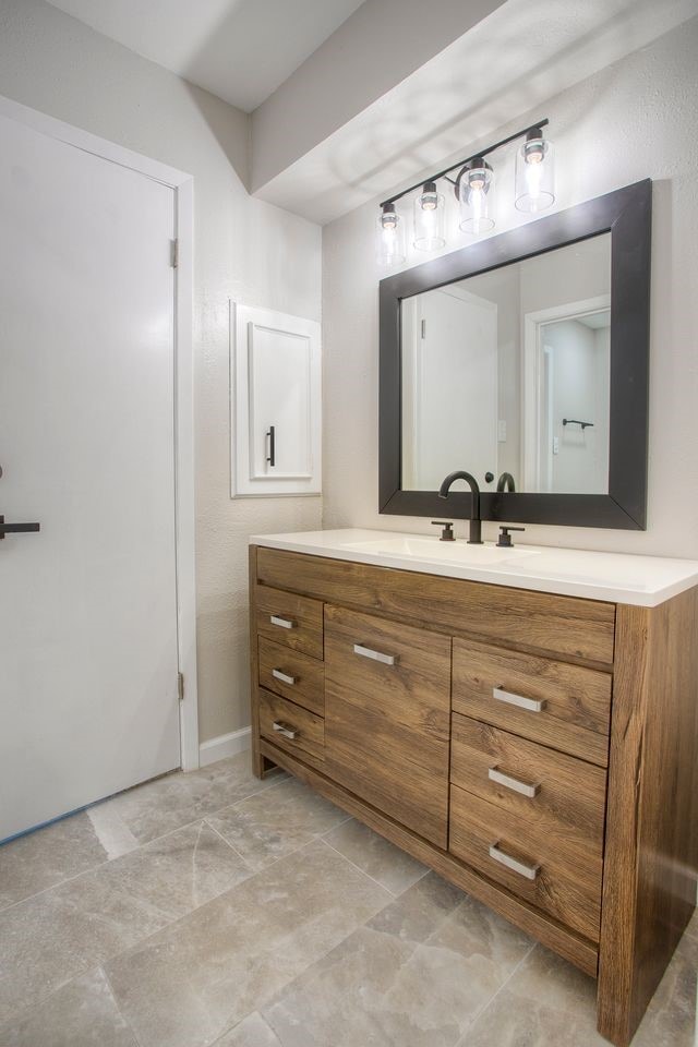 bathroom with baseboards and vanity