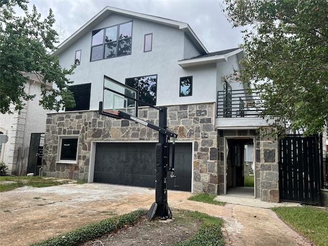 view of front of home with a balcony and a garage