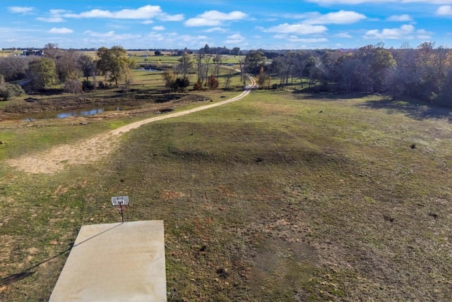 birds eye view of property featuring a rural view and a water view