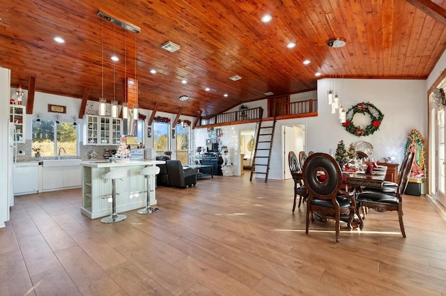 interior space featuring light wood-type flooring, white cabinetry, and a wealth of natural light