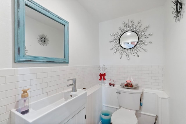 bathroom with tile walls, backsplash, toilet, and vanity