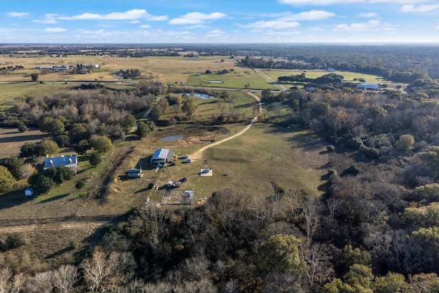 birds eye view of property with a rural view and a water view