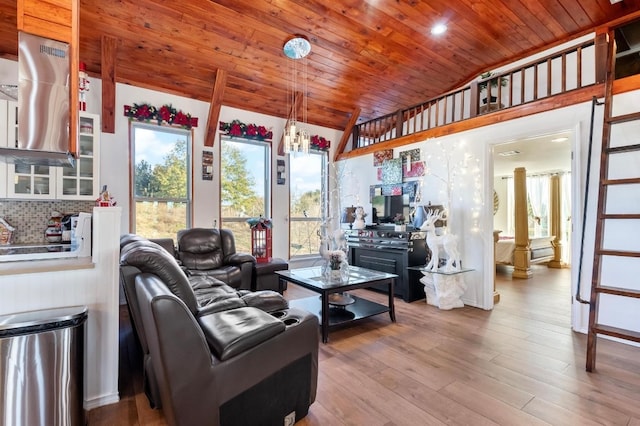 living room featuring wood ceiling, a healthy amount of sunlight, and hardwood / wood-style floors