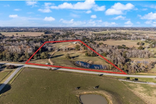 birds eye view of property with a rural view