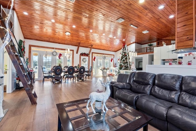 living room featuring wood ceiling, a healthy amount of sunlight, wood-type flooring, and french doors